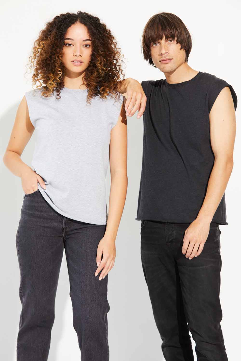 A woman and man standing wearing Standard Issue Cotton Kiri Tanks.