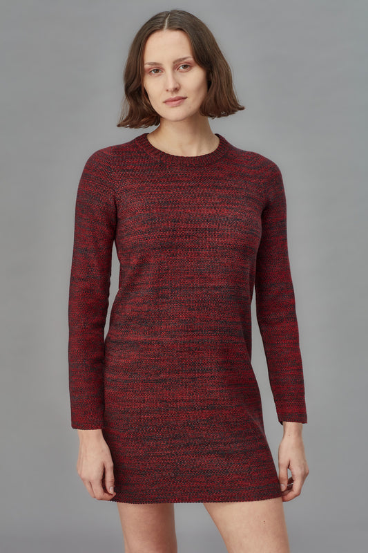 Woman wearing a red and black patterned dress against a gray background