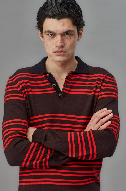 Man wearing a brown and red striped shirt against a gray background